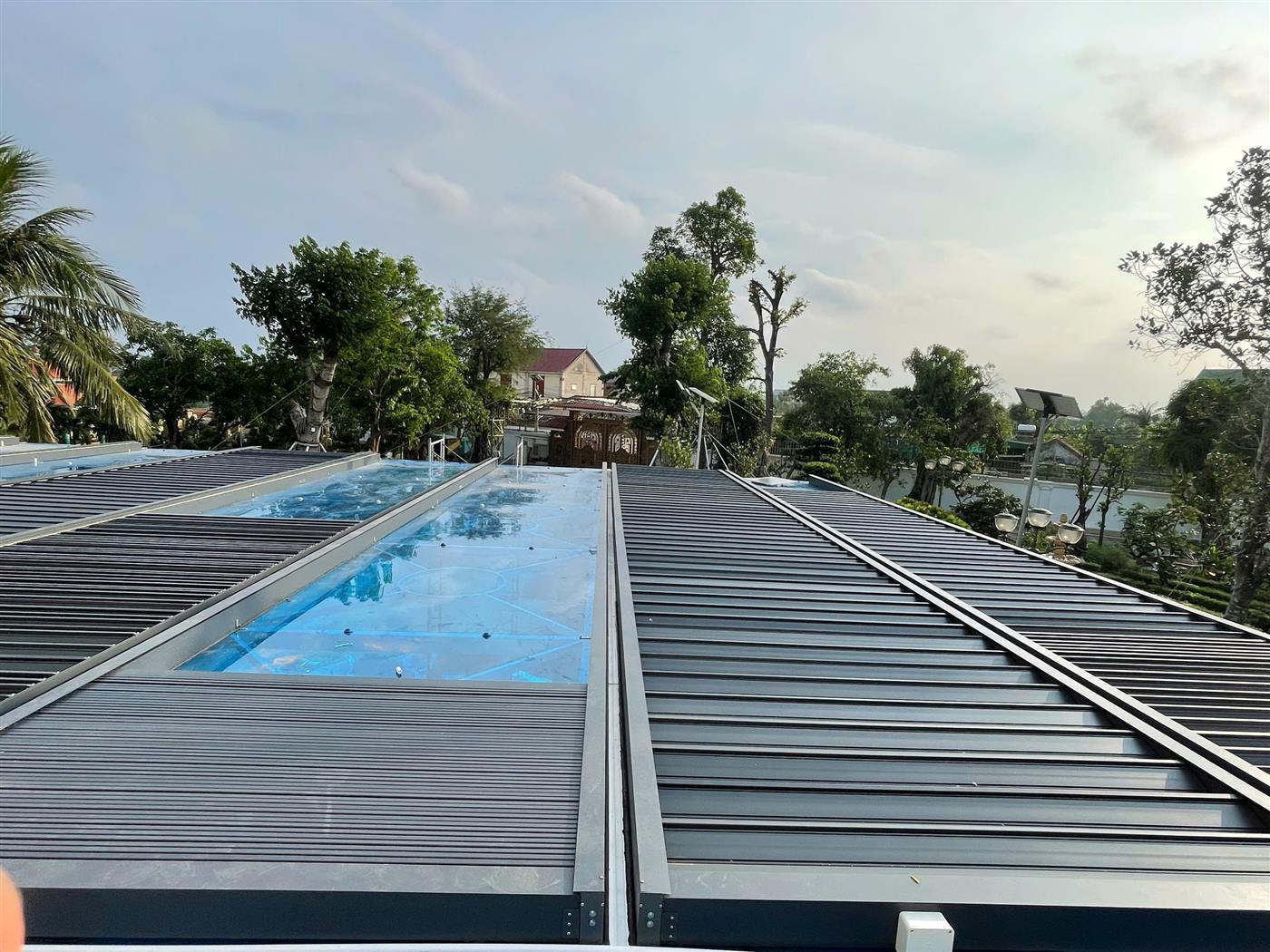 Chống nóng giếng trời bằng hai dải mái nhôm xếp tự động phía trên mặt kính